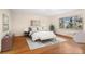 Bright bedroom featuring hardwood floors and treetop views at 7076 Inspiration Dr, Parker, CO 80138