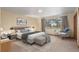 Main bedroom with carpet flooring and a cozy sitting area at 7076 Inspiration Dr, Parker, CO 80138