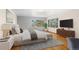 Main bedroom with king-size bed, large windows, and hardwood floors at 7076 Inspiration Dr, Parker, CO 80138