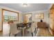 Bright dining room with glass table and view into living room at 7076 Inspiration Dr, Parker, CO 80138