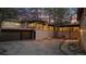 Back exterior view of home with landscaping and large windows at 7076 Inspiration Dr, Parker, CO 80138