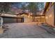 Home exterior showcasing a two-car garage and landscaping at 7076 Inspiration Dr, Parker, CO 80138