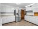 Bright kitchen with stainless steel appliances and white cabinetry at 7076 Inspiration Dr, Parker, CO 80138