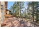 Brick patio with metal chairs and wooded views at 7076 Inspiration Dr, Parker, CO 80138