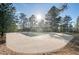 Empty rectangular pool with surrounding concrete deck and trees at 7076 Inspiration Dr, Parker, CO 80138
