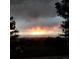 Fiery sunset over city skyline and mountains at 7076 Inspiration Dr, Parker, CO 80138