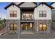 Two-story home showcasing a covered patio, balcony, stone accents, and numerous windows for natural light at 7022 Homeplace St, Castle Rock, CO 80108