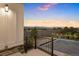 Backyard patio offering stunning sunset views of the surrounding landscape and retaining wall at 7022 Homeplace St, Castle Rock, CO 80108
