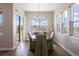 Bright dining room featuring a round table, chandelier, and large windows offering abundant natural light at 7022 Homeplace St, Castle Rock, CO 80108
