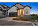 Charming two-story home with a black garage door, stone accents, and inviting front entry at 7022 Homeplace St, Castle Rock, CO 80108