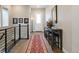 Elegant hallway features hardwood floors, console table, floral arrangement and staircase at 7022 Homeplace St, Castle Rock, CO 80108
