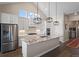 Open kitchen with granite countertops, stainless steel appliances, pendant lighting, and white cabinetry at 7022 Homeplace St, Castle Rock, CO 80108