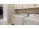 Efficient laundry room with white cabinets, washer, dryer, and a sink for added convenience at 7022 Homeplace St, Castle Rock, CO 80108