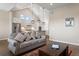 Open-concept living space with a comfortable sofa and a view of the modern kitchen with stainless steel appliances at 7022 Homeplace St, Castle Rock, CO 80108