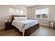 Comfortable main bedroom featuring a large bed with patterned bedding and ample natural light from the windows at 7022 Homeplace St, Castle Rock, CO 80108