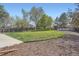 A beautifully landscaped yard with lush greenery, mature trees, and wooden playset at 13330 York Way, Thornton, CO 80241