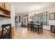 Bright kitchen with hardwood floors, stainless steel appliances, a dining table, and easy access to outdoor spaces at 13330 York Way, Thornton, CO 80241