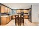 Well-equipped kitchen featuring stainless steel appliances, wooden cabinets, a center island, and hardwood floors at 13330 York Way, Thornton, CO 80241