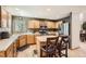 Bright kitchen with stainless steel appliances, light wood cabinets, an island, and hardwood floors at 13330 York Way, Thornton, CO 80241