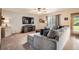 Inviting living room features a large sectional couch, media center, and natural light at 13330 York Way, Thornton, CO 80241