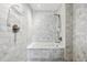 Modern bathroom with white marble tile, a shower, and a built-in tub at 1750 Wewatta St # 627, Denver, CO 80202