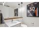 Modern bathroom features a floating vanity, large mirror and football decor at 1750 Wewatta St # 627, Denver, CO 80202