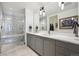 Modern bathroom with double vanity, sleek fixtures, and a glass-enclosed shower at 1750 Wewatta St # 627, Denver, CO 80202