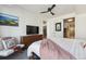 Bright bedroom featuring a dresser, chair, television, and a view of the kitchen at 1750 Wewatta St # 627, Denver, CO 80202