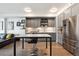 Modern kitchen with stainless steel appliances, gray cabinetry and countertop dining area at 1750 Wewatta St # 627, Denver, CO 80202