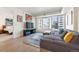 Spacious living room featuring hardwood floors, city views, and a cozy seating area at 1750 Wewatta St # 627, Denver, CO 80202