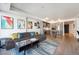 Open-concept living area with a sleek sectional sofa and a view of the kitchen at 1750 Wewatta St # 627, Denver, CO 80202