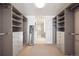 Spacious walk-in closet with custom shelving and a view of the bathroom at 1750 Wewatta St # 627, Denver, CO 80202