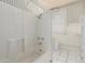 Bathroom featuring white fixtures, tiled floor, and blue striped wallpaper at 931 E 17Th Ave, Denver, CO 80218