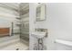 Accessible bathroom with a roll-in shower featuring grab bars and a fold-down seat, plus a small sink at 931 E 17Th Ave, Denver, CO 80218