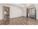 Bright bedroom with an open doorway, painted trim, luxury vinyl floors, and ceiling fan at 931 E 17Th Ave, Denver, CO 80218