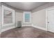 Bedroom featuring dark wood floors, two windows, radiator, and door at 931 E 17Th Ave, Denver, CO 80218