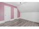 Bright bedroom with a modern light fixture, fresh paint, and contemporary gray vinyl floors at 931 E 17Th Ave, Denver, CO 80218