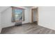 Bedroom featuring wood-look flooring, a window with curtains, radiator, and doorway at 931 E 17Th Ave, Denver, CO 80218
