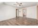 Spacious bedroom with a ceiling fan, hardwood floors, painted trim, and two open doorways at 931 E 17Th Ave, Denver, CO 80218