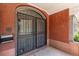 Close-up view of the entrance with secure gates, brick facade and traditional design elements at 931 E 17Th Ave, Denver, CO 80218