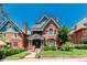 Charming brick home featuring detailed gables, arched windows, and a well-maintained front yard with mature landscaping at 931 E 17Th Ave, Denver, CO 80218