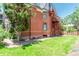 View of the brick home showing the green lawn and outdoor fire escape at 931 E 17Th Ave, Denver, CO 80218