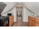 Compact kitchen features a stove, microwave, wood cabinets, and sink open to a bedroom at 931 E 17Th Ave, Denver, CO 80218