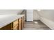 Small kitchenette with warm wood cabinets, long counter, and a tall refrigerator in a compact space at 931 E 17Th Ave, Denver, CO 80218