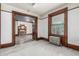 Living room featuring tall window, radiator, wood trim, and doorway to fireplace room at 931 E 17Th Ave, Denver, CO 80218