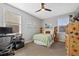 Comfortable bedroom with a ceiling fan, desk, climbing wall and windows providing natural light at 2773 Havana St, Denver, CO 80238