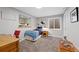 Neutral bedroom includes a small bed, carpeted floors, and egress window and an alcove with toys at 2773 Havana St, Denver, CO 80238