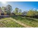 Lush green backyard with brick pathway leading to the home at 9345 W Iowa Pl, Lakewood, CO 80232