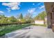 Spacious backyard with shed and a newly poured concrete patio, perfect for entertaining at 9345 W Iowa Pl, Lakewood, CO 80232
