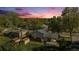 Backyard view features a well-kept lawn, mature trees, and a cozy home exterior with a patio at 9345 W Iowa Pl, Lakewood, CO 80232